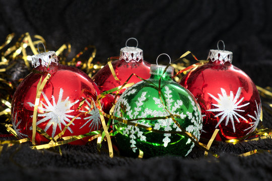 Colored Christmas balls on black velvet