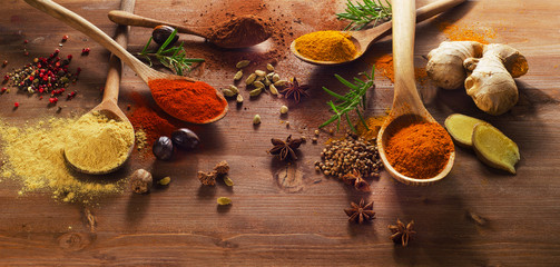 Spices and herbs on wooden table.