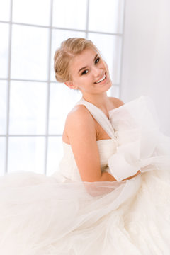 Happy bride standing in white wedding dress