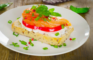 Sandwich with cereals bread and salmon on a old wooden backgroun