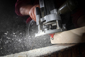 drill machine drilling a wood board