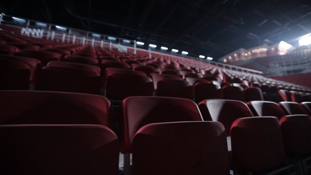 Camera tracks to reveal empty seats in a basketball arena