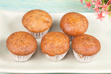 banana cup cake on wood deck .
