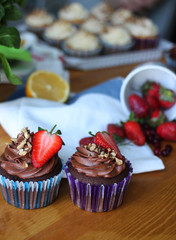 Sweet cupcakes decorated with strawberry,chocolate cream and nuts