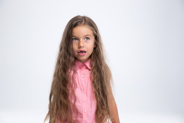 Portrait of amazed little girl looking away