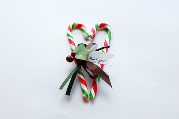 Christmas red and green candy cane with thank you note in heart