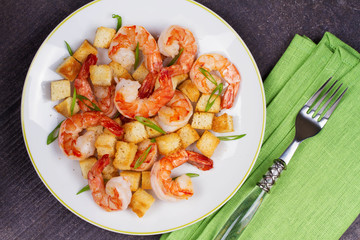 Shrimp with crispy croutons and scallions. View from above, top studio shot