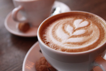 two cups with creamy cappuccino