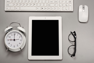 White tablet computer with a alarm clock, keyboard, computer mou