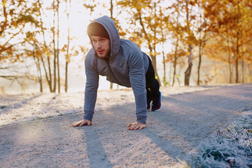 Runner doing push ups during morning workout - healthy lifestyle