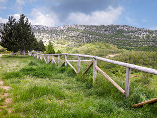 Fototapeta premium Mountain landscape with wooden fence