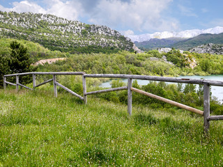Fototapeta na wymiar Mountain landscape with wooden fence and lake