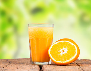 Glass of orange juice with vegetables on table