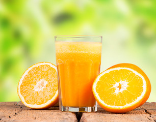Glass of orange juice with vegetables on table