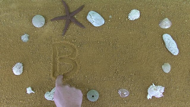 The inscription "bar" written word finger in the sand. Bordered by rocks and seashell