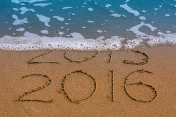 Happy New Year 2016 replace 2015 concept on the sea beach.
