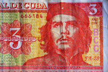 Portrait of Ernesto Che Guevara, historical leader of Cuba on three peso banknotes.