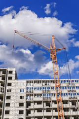 Fototapeta premium Multistorey houses and large crane
