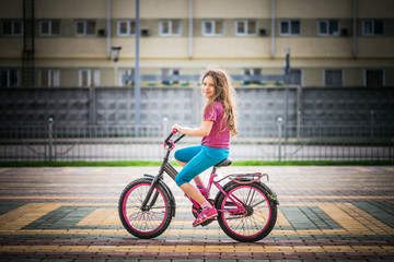 Obraz na płótnie Canvas little girl riding bicycle