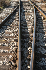 Railroad iron rails old sleepers and gravel closeup
