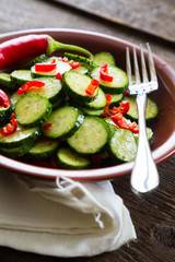 Fresh salad of cucumbers with red hot chili pepper