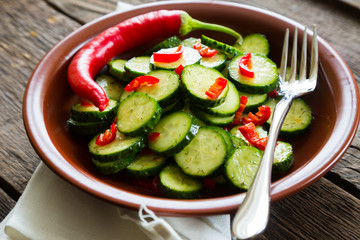 Fresh salad of cucumbers with red hot chili pepper