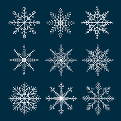 Set of doodle snowflakes isolated on dark background. Winter collection. Hand drawn vector symbols.