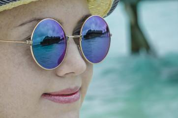 The girl in sunglasses with reflection in them water bungalows