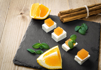 Snack cheese with quince and fresh oranges