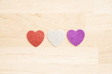Thre hearts on wooden background
