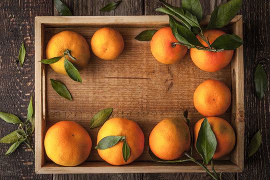 Tangerines on the wooden tray horizontal