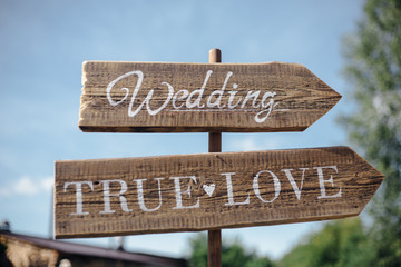 a wooden plaque with the inscription hanging on the tree in forest