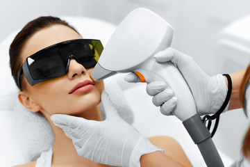 Face Care. Facial Laser Hair Removal. Beautician Giving Laser Epilation Treatment To Young Woman's Face At Beauty Clinic. Body Care. Hairless Smooth And Soft Skin. Health And Beauty Concept.