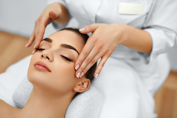 Fototapeta na wymiar Skin And Body Care. Close-up Of A Young Woman Getting Spa Treatment At Beauty Salon. Spa Face Massage. Facial Beauty Treatment. Spa Salon.
