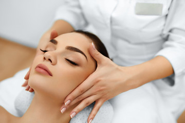 Fototapeta na wymiar Skin And Body Care. Close-up Of A Young Woman Getting Spa Treatment At Beauty Salon. Spa Face Massage. Facial Beauty Treatment. Spa Salon.