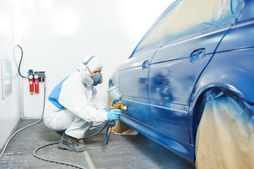 worker painting auto car body