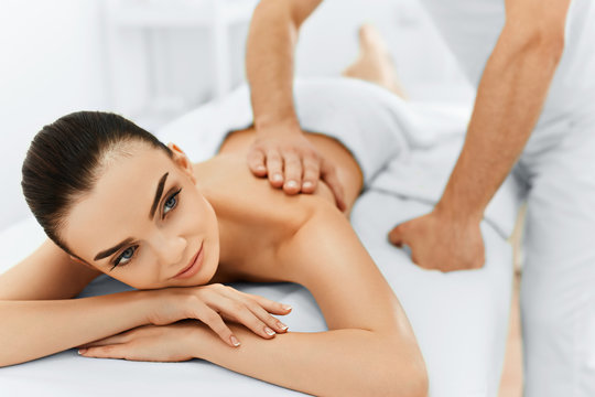Body Care. Spa Woman. Beauty Treatment Concept. Masseur Doing Hand Massage On Relaxed Beautiful Young Caucasian Woman's Body In The Spa Salon. Skin Care, Wellness, Wellbeing.