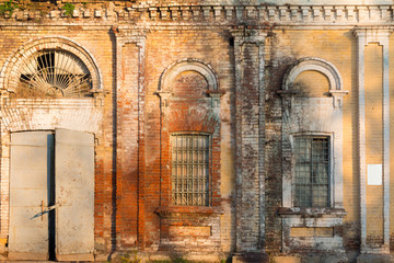 Abandoned industrial building. Old brick warehouse building facade.