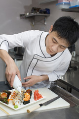 Japanese chef preparing a meal in a restaurant