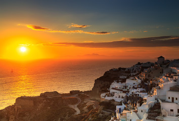 sunset over famous blue and white city Oia,Santorini