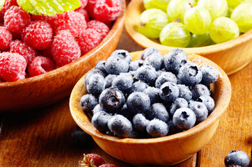 Wooden bowls with organic berries