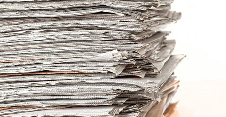 stack of daily newspapers isolated on white background. news, information, media