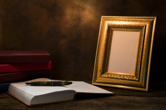 still life of picture frame on table with diary book