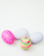 Easter eggs painted in pastel colors on a white background