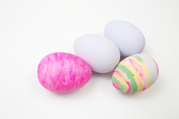 Easter eggs painted in pastel colors on a white background