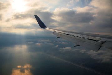 Airplane wing against ray light