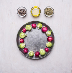 Healthy foods brussels sprouts in a pan with butter and radish seasonings on wooden rustic background top view close up