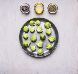 Brussels sprouts in a pan with butter and seasonings healthy foods, cooking and vegetarian concept on wooden rustic background top view close up