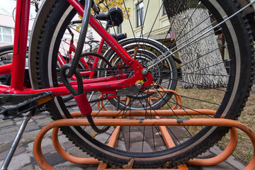 Wheel stoyaschik parked bicycle closeup. Urban transport