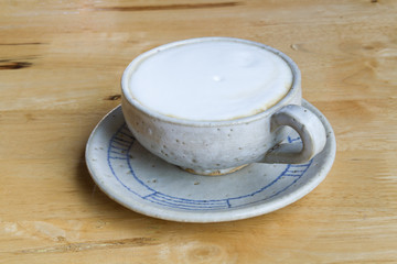 Close up Vintage cup of Coffee, latte on wooden background